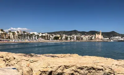 a view of a beach with buildings and the water at Apartamento Montroig 3 Ático in Sitges