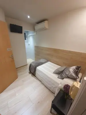 a bedroom with a bed and a table in it at Pensión San Ramón in Barcelona
