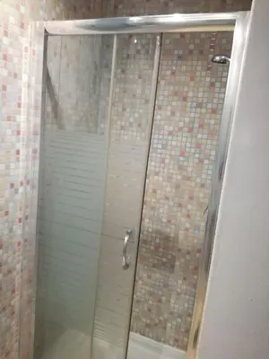 a shower with a glass door in a bathroom at Pensión San Ramón in Barcelona