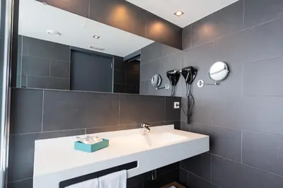 a bathroom with a sink and a mirror at Atenea Port Barcelona Mataró in Mataró