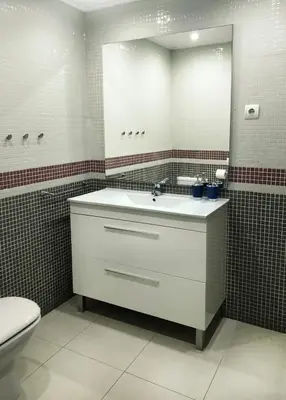 a bathroom with a sink and a mirror and a toilet at Apartamento Montroig 1 in Sitges
