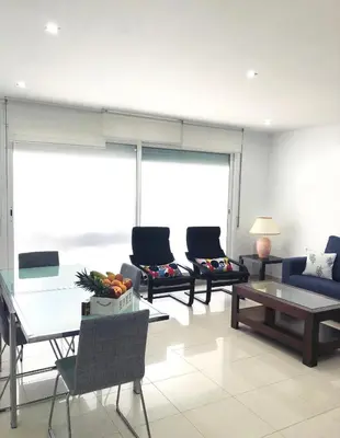a living room with two couches and a table at Apartamento Montroig 1 in Sitges