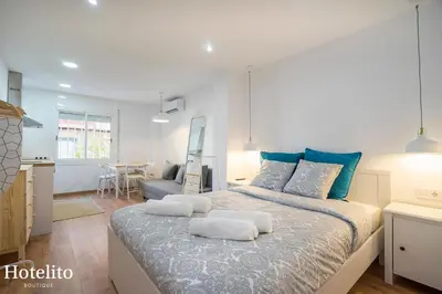 a bedroom with a large bed with two pillows on it at Hotelito Boutique Mercat in Hospitalet de Llobregat