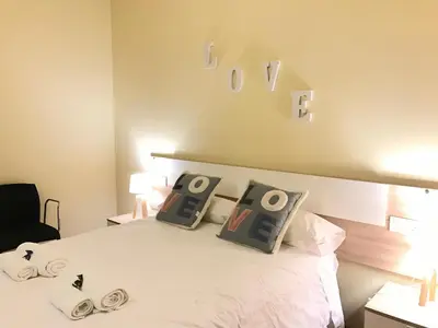 a bedroom with a bed with pillows on it at Duplex in Santa María de Barbará