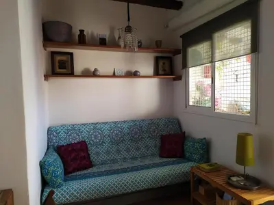 a living room with a blue couch and two windows at Penthouse Pza España - 4th Floor in Barcelona