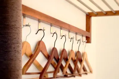 a row of wooden hangers on a wall at Hostal Poblenou in Barcelona