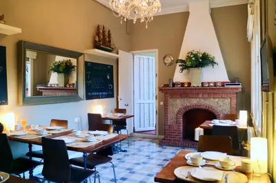 a dining room with tables and a fireplace at Hostal Poblenou in Barcelona