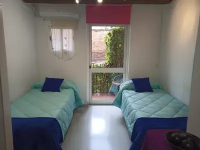 two beds in a room with a window at Estudio con balcon Plaza España in Barcelona