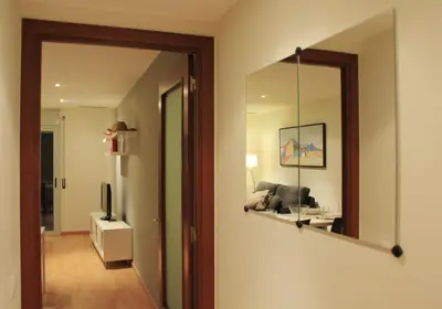 a living room with a mirror and a couch at Alguera Apartments Industria in Barcelona