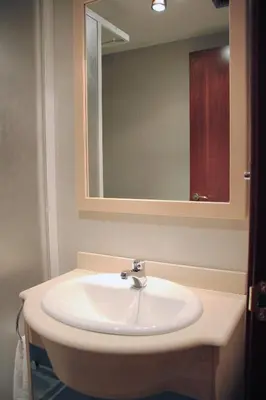 a white sink in a bathroom with a mirror at Alguera Apartments Industria in Barcelona