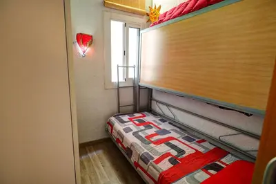 a small room with a bed and a window at Aquarium Apartment by Hello Homes Sitges in Sitges