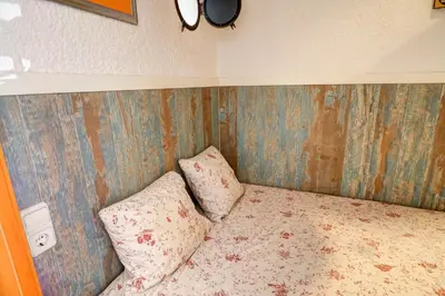 a bed with two pillows in a bedroom at Aquarium Apartment by Hello Homes Sitges in Sitges