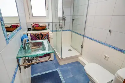a bathroom with a sink and a shower at Aquarium Apartment by Hello Homes Sitges in Sitges
