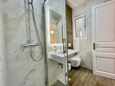 a bathroom with a shower and a sink and a toilet at The Gaudi Suites in Barcelona