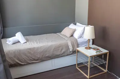 a bed with a side table with a lamp on it at The Vintage Rentals in Barcelona