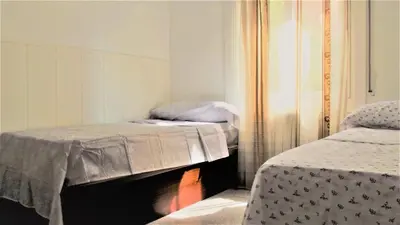 a room with two beds and a fireplace in it at Apartamentos Atlas Terrassa III in Terrassa
