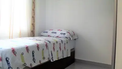 a small bedroom with a bed with a hello kitty blanket at Apartamentos Atlas Terrassa III in Terrassa