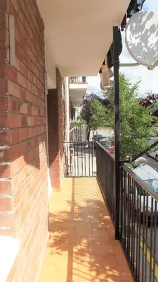 a porch of a house with a brick wall at Apartamentos Atlas Terrassa III in Terrassa