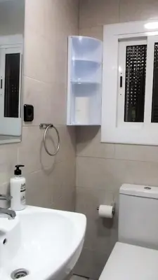 a bathroom with a white sink and a toilet at Apartamentos Atlas Terrassa III in Terrassa