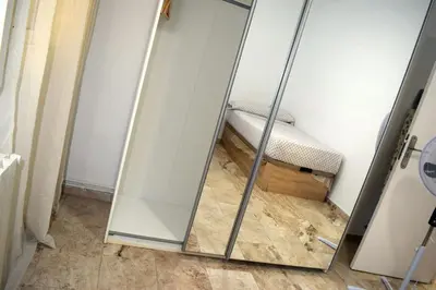 a mirror in the corner of a room with a bed at Apartamentos Atlas Terrassa II in Terrassa