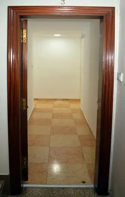 a door leading into a hallway with a tile floor at Apartamentos Atlas Terrassa II in Terrassa