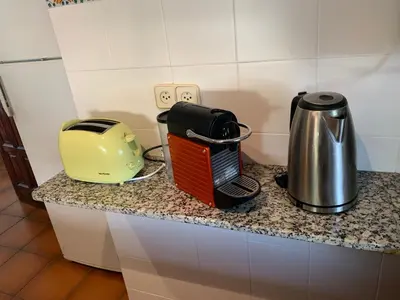 a toaster and a toaster sitting on a counter at Apartament Cal Negre in Vilassar de Mar