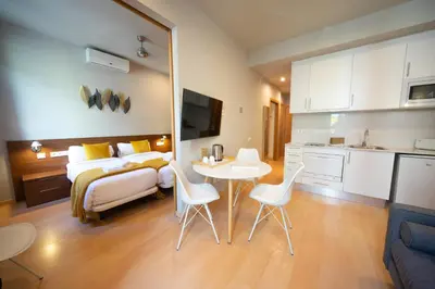 a bedroom with a bed and a table and chairs at Bonavista Apartments - Eixample in Barcelona