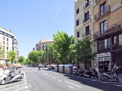 a row of motorcycles parked on the side of a street at Bonavista Apartments - Eixample in Barcelona