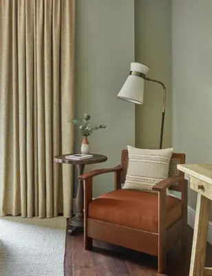 a room with a chair and a lamp and a table at Miiro Borneta in Barcelona