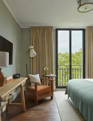 a bedroom with a bed and a desk and a window at Miiro Borneta in Barcelona