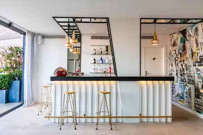 a bar with gold stools and a mirror at Vincci Bit in Barcelona