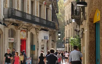 a crowd of people walking down a city street at Hostal Fina in Barcelona