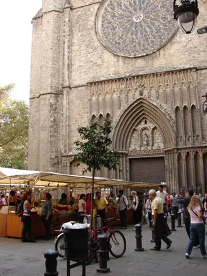 a group of people walking in front of a church at Hostal Fina in Barcelona
