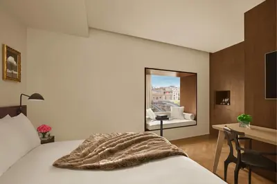 a bedroom with a bed with a blanket on it at The Barcelona EDITION in Barcelona
