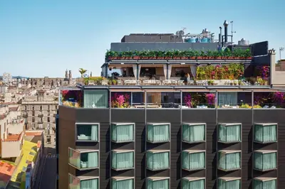 a building with a balcony with plants on it at The Barcelona EDITION in Barcelona