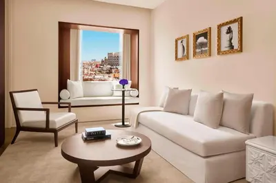 a living room with a white couch and a table at The Barcelona EDITION in Barcelona