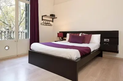 a bedroom with a large bed and a window at BruStar Gotic-Centric in Barcelona