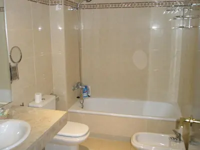 a bathroom with a tub and a toilet and a sink at Playa y Sol in Cubelles