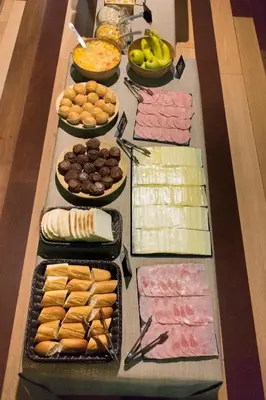 a table with many different types of food on it at Kabul Party Hostel Barcelona in Barcelona
