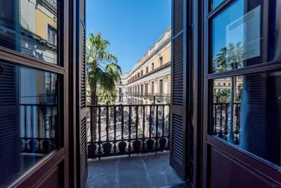 an open door to a balcony with palm trees at Kabul Party Hostel Barcelona in Barcelona