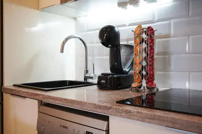 a kitchen counter with a sink and a coffee maker at Calm, Beach and Bikes in Castelldefels