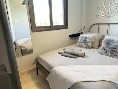 a bedroom with two beds and a mirror at 8 min walk to the beach & 10 min walk to Convention Centre ! in Barcelona