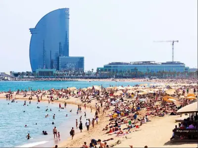 a group of people on a beach in the water at 8 min walk to the beach & 10 min walk to Convention Centre ! in Barcelona