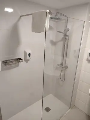 a bathroom with a shower with a glass door at Hotel Blauet by Bossh! Hotels in El Prat de Llobregat