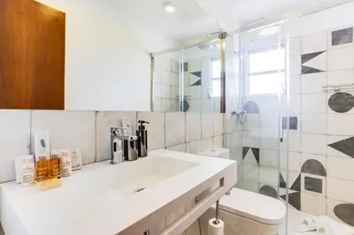 a bathroom with a white sink and a shower at Sweett - Eixample Borrell in Barcelona