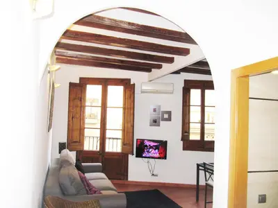 a living room with a couch and a tv at Top Barcelona Apartments in Barcelona