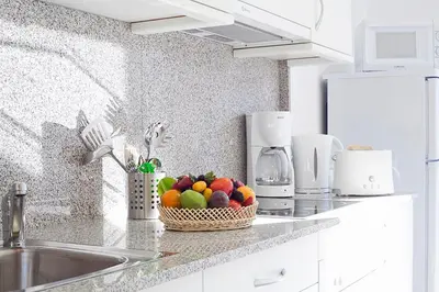 a kitchen with a basket of fruit on a counter at Charmsuites Nou Rambla in Barcelona