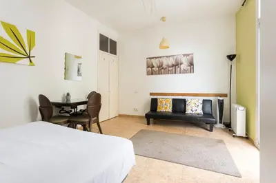 a bedroom with a bed and a table and chairs at Apartament Clot 1 in Barcelona