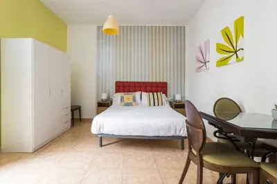 a bedroom with a bed and a table and chairs at Apartament Clot 1 in Barcelona
