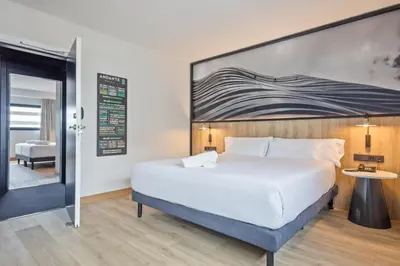 a hotel room with a bed and a sign on the wall at Andante Hotel in Barcelona